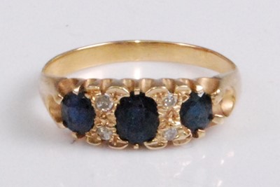 Lot 2055 - A yellow metal, sapphire and diamond...