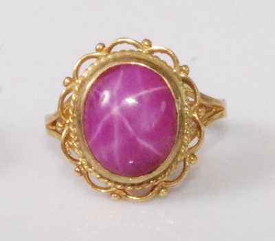Lot 2190 - A 9ct gold 'synthetic' pink star sapphire set...