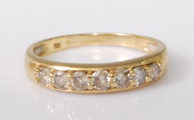 Lot 2230 - An 18ct gold diamond half hoop ring, the seven...
