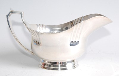 Lot 71 - An Art Deco silver sauceboat, the plain body...