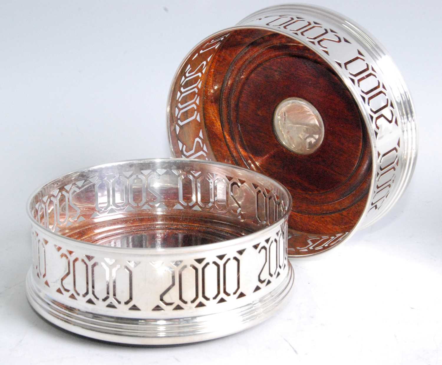 Lot 1097 - A pair of modern silver wine bottle coasters,...
