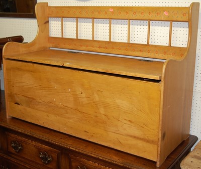 Lot 1137 - A stained pine hinge topped two-seater boxseat...