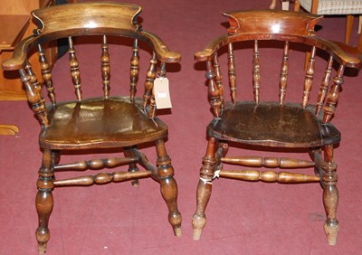 Lot 1170 - An early 20th century elm tub captain's chair;...