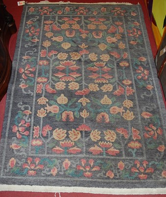 Lot 1175 - A Persian style woollen rug, decorated with...