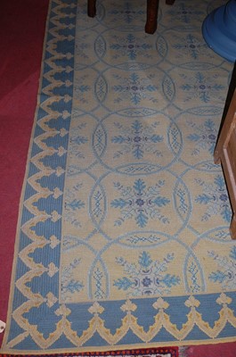 Lot 1182 - A large European machine woven rug, decorated...