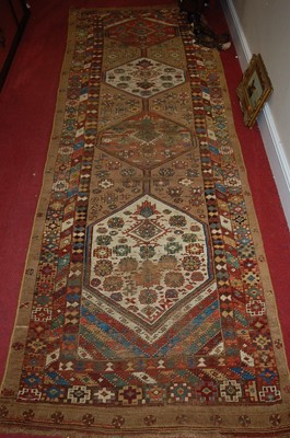 Lot 1183 - A Persian woollen brown ground hall runner,...