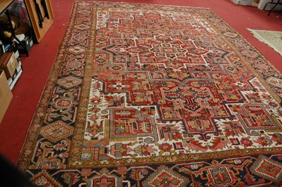 Lot 1184 - A Persian woollen red ground rug, of good size,...