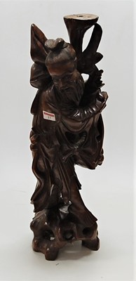 Lot 27 - A Far Eastern carved hardwood peasant figure,...