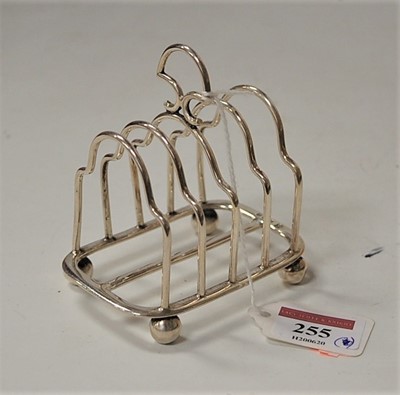 Lot 255 - An Edwardian silver four-division toast-rack,...