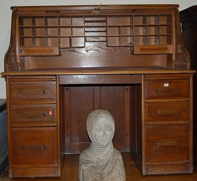 Lot 1191 - A 1930s oak rolltop twin pedestal writing desk,...