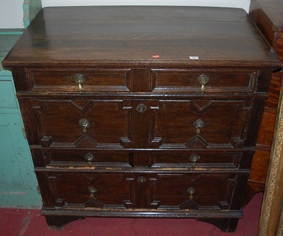 Lot 1202 - An antique geometric moulded oak chest, of...