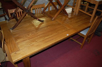 Lot 1264 - A contemporary light elm extending dining...