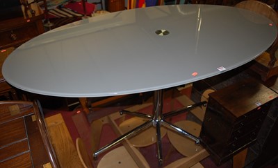 Lot 1292 - A contemporary smoky glass topped oval...