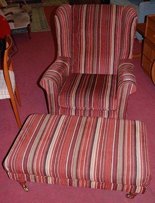 Lot 1318 - A contemporary striped upholstered wingback...