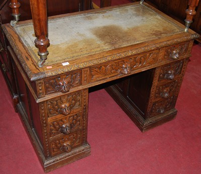 Lot 1379 - A circa 1900 floral relief and line carved oak...
