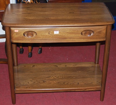 Lot 1381 - A contemporary Ercol mid-elm single drawer two-...