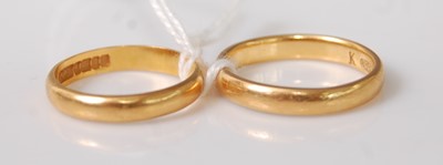 Lot 355 - A plain 22ct gold wedding band, size K; and...