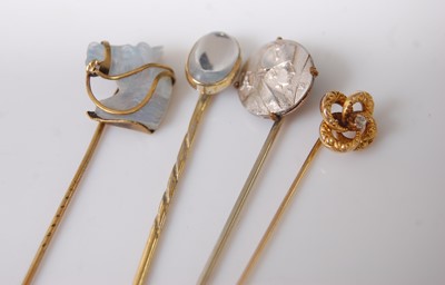 Lot 384 - Four various stick pins, to include moonstone...