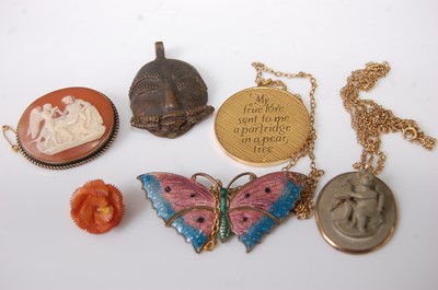 Lot 401 - A carved lava stone pendant, in yellow metal...