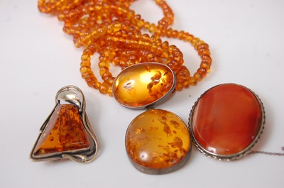 Lot 411 - A faux orange amber multi-string necklace with...