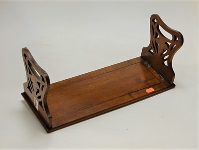 Lot 109 - A Victorian walnut book trough, having pierced...