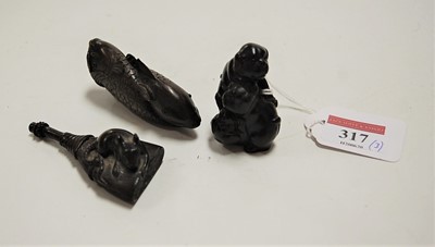Lot 317 - A collection of three carved wooden netsuke,...