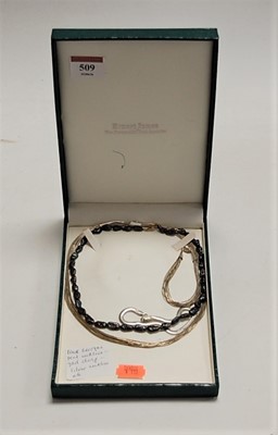 Lot 509 - A black Baroque pearl single string necklace,...
