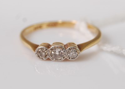 Lot 358 - An 18ct gold diamond three-stone ring, the...