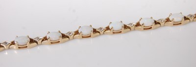 Lot 365 - A modern 9ct gold, opal and diamond point set...