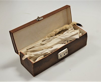 Lot 519 - A brown leather glove box containing various...
