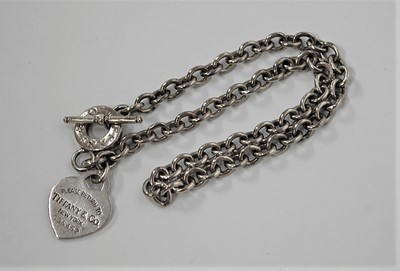 Lot 423 - A Tiffany & Co STYLE white metal identity neck...