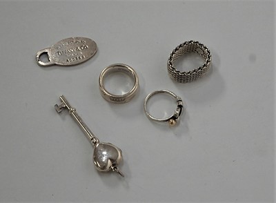 Lot 430 - A Tiffany & Co silver band ring; together with...