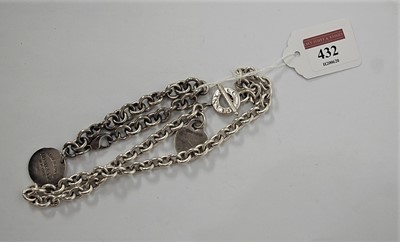Lot 432 - A Tiffany & Co STYLE white metal identity neck...