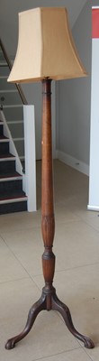 Lot 1418 - A mahogany standard lamp, raised on floral...