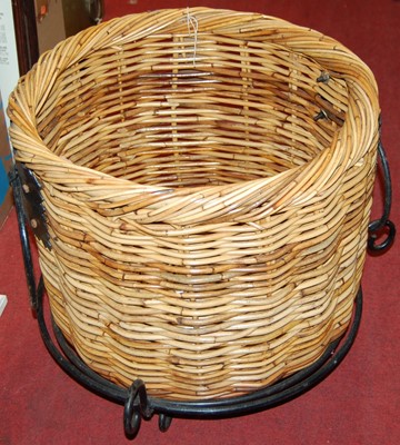 Lot 1090 - A wicker log basket, on wrought iron stand