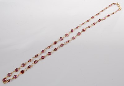Lot 1194 - A yellow metal and garnet set multi-stone...