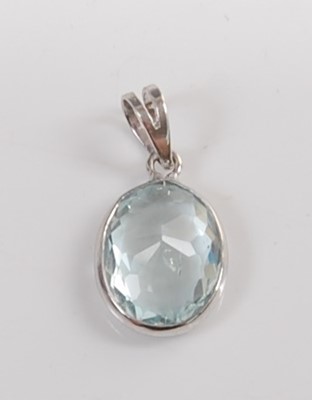 Lot 1198 - A white metal and aquamarine pendant, the oval...