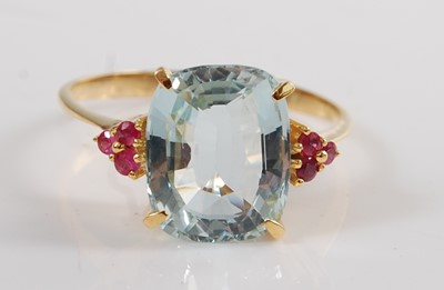 Lot 1193 - A yellow metal, aquamarine and ruby dress ring,...