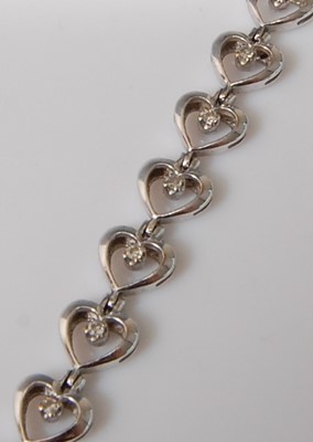 Lot 2506 - A 9ct white gold diamond line bracelet,...