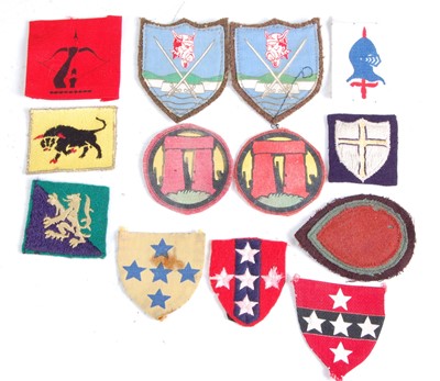 Lot 34 - A collection of WW II and later British Army formation signs to include