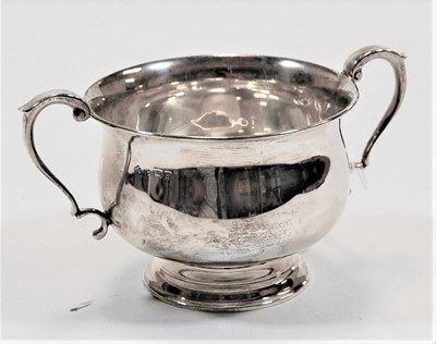 Lot 269 - A silver twin handled cup, standing on a...