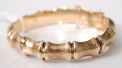 Lot 344 - A 9ct gold simulated bamboo hinged bangle,...