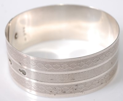 Lot 387 - A Charles Horner engine turned silver bangle,...