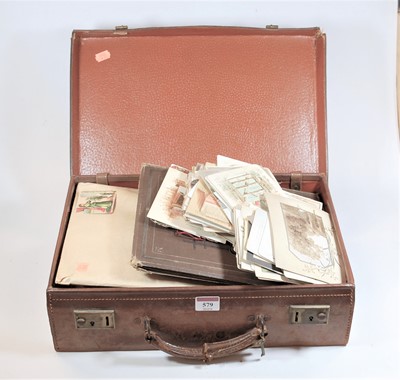 Lot 579 - A small stitched leather suitcase and contents...