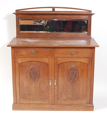 Lot 290 - An Arts & Crafts oak ledgeback side cupboard,...