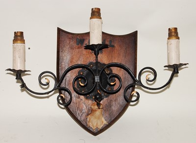 Lot 668 - * A mid-20th century wrought iron three sconce...