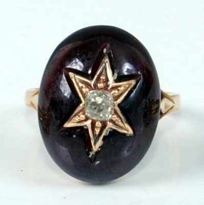 Lot 1206 - A yellow metal oval garnet mourning ring,...