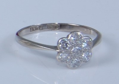 Lot 1208 - A white metal diamond circular cluster ring,...