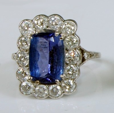 Lot 1227 - A white metal, tanzanite and diamond oblong...