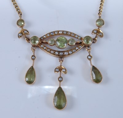 Lot 1237 - A 9ct yellow gold Edwardian style peridot and...